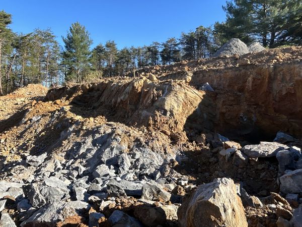 Heavy equipment working through stubborn rock