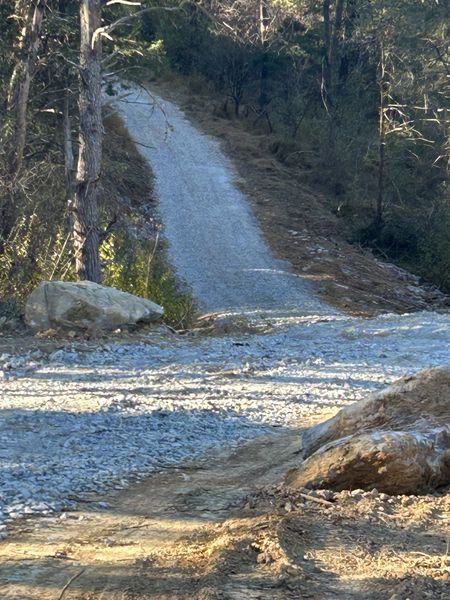 Early gravel base being shaped for the driveway